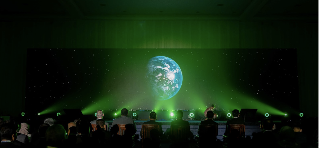 Image of a crowd with a projection of the Earth. Included in a blog post about COP28.